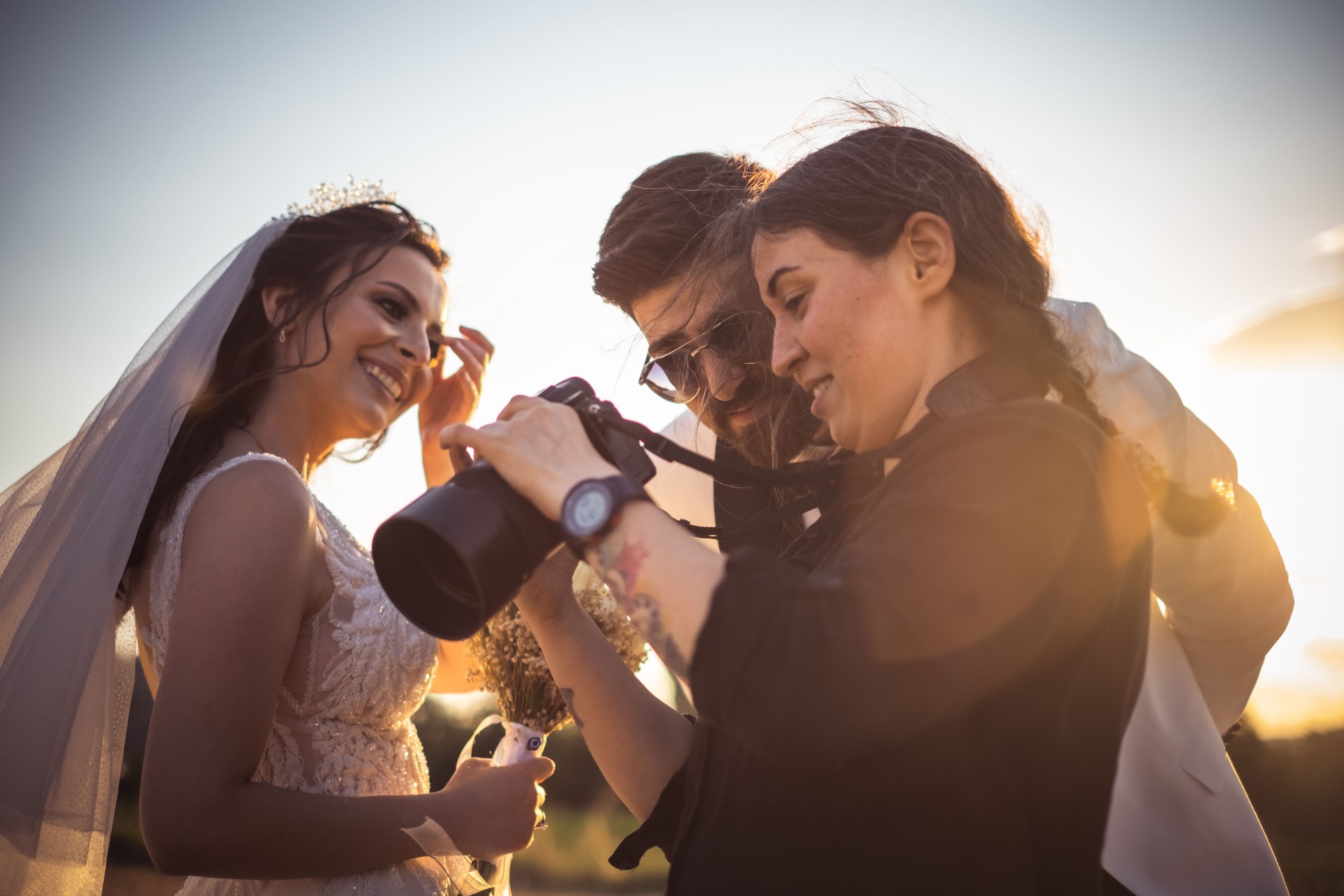 Wedding photographer showing the photos to the couple