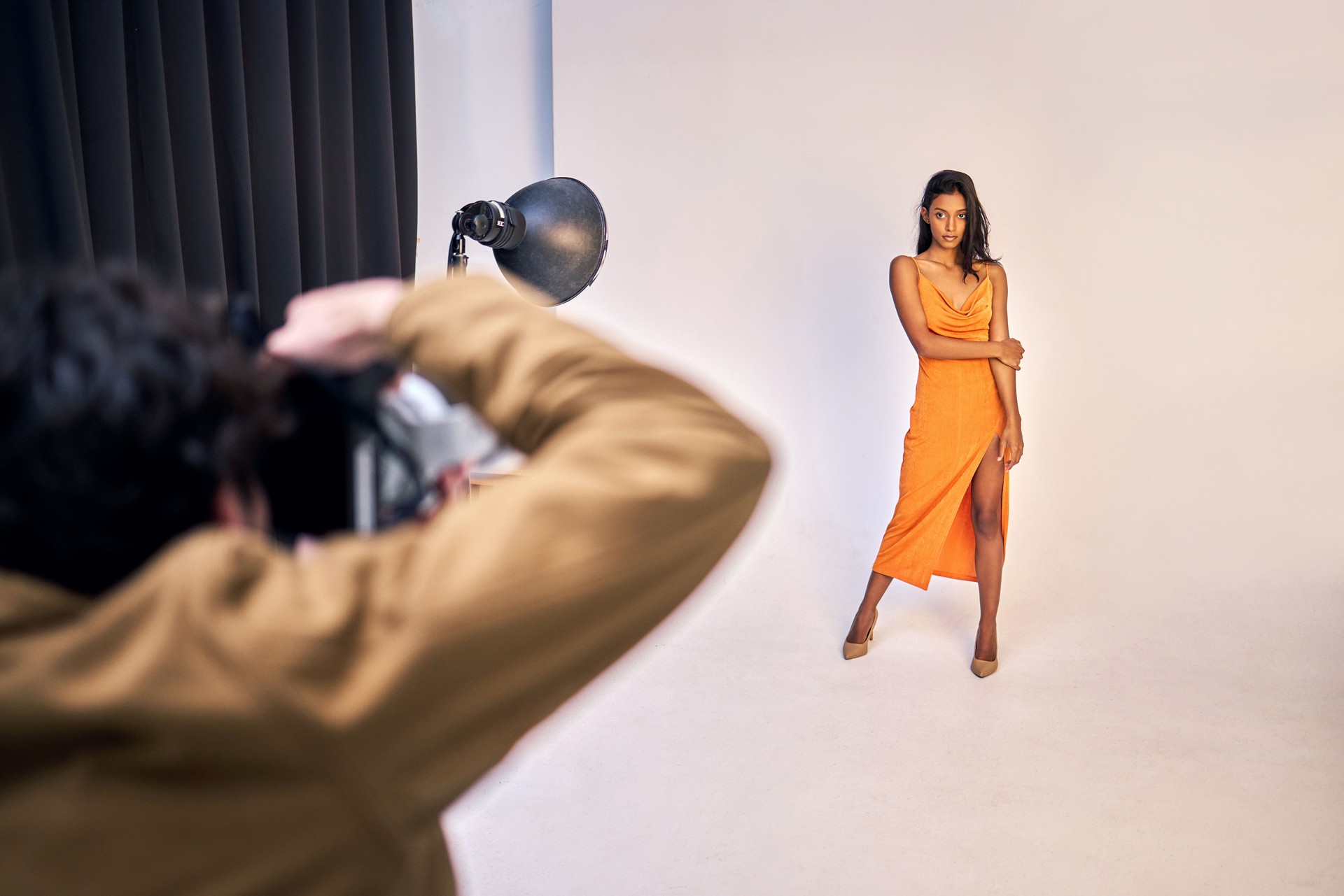 Shot of a photographer taking photos of a model in a studio